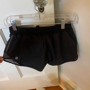 Black lulu lemon athletic shorts with tie and zipper back pocket